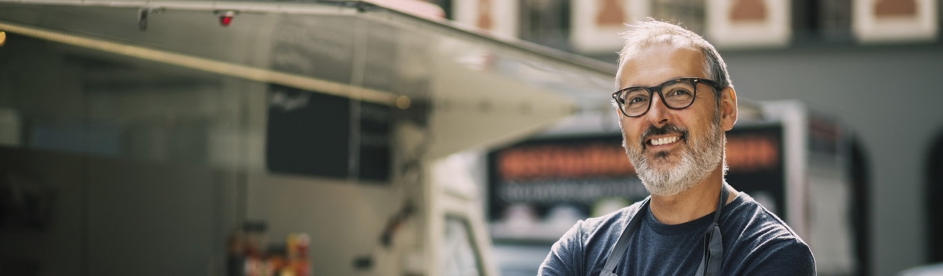 Man standing by his food truck