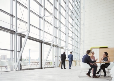 Group of Business People Meeting at Table in Office Lobby